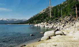 Lake Tahoe water front has a combination of sand and rock that offers beach combers interest